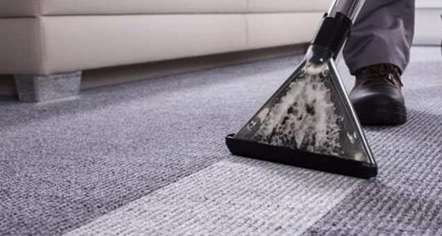 Extraction cleaning lifting dirt out of a grey carpet